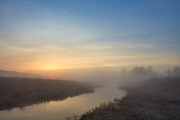 Fototapeta na wymiar morning fog over the river red dawn