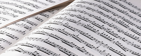 A music book open with music notes in black and white