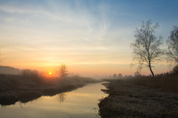 Naklejka na ściany i meble morning fog over the river red dawn