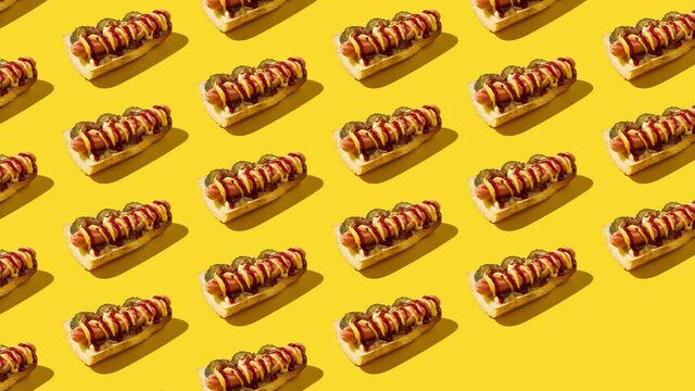 Stop motion animation. Open sandwiches  appear and disappear diagonally on yellow background. American junk food concept.
