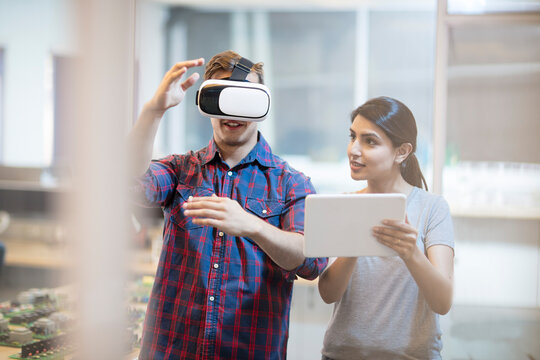 Colleagues using a VR headset