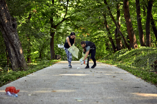 Couple plogging on forest path