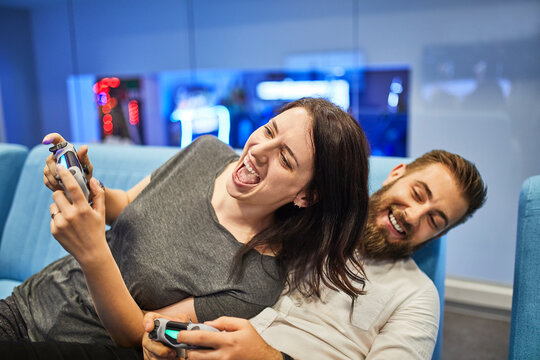 Couple playing and having fun in an amusement arcade