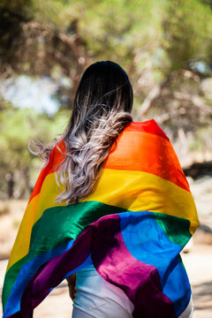 Rear view of woman with pride flag