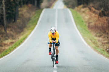 Young sportsperson cycling on road