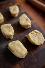 Yeast dough divided into pieces. Technique for making sweet pastries at home