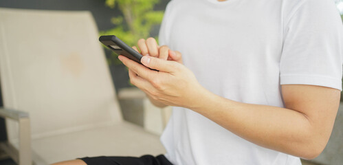 slow motion scene young middle eastern man hold smartphone to use by surfing the internet or read...