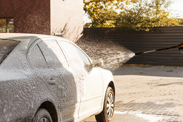 Applying active foam on the car at self-service car wash