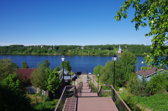 Tutaev, Russia - May, 2021: Volga river embankment on a spring day and a view of the Romanovskaya side of Tutaev