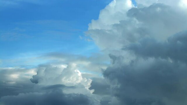 Amazing time lapse with clouds, sky concept, white fluffy clouds swirling, dark sky background