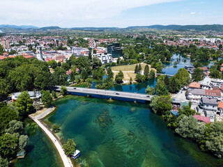 Fototapeta na wymiar Aerial drone view Bihac and Una river in Bosnia and Herzegovina. Buildings, streets and residential houses. Bihać is a town and municipality in western BiH.