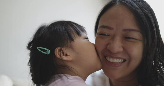4K Video slow motion Asian mom and little daughter play and kiss each other. Concept of love and connection of mother and kid.