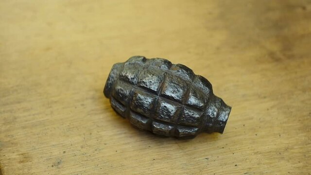 old rusty hand grenade rotating close-up