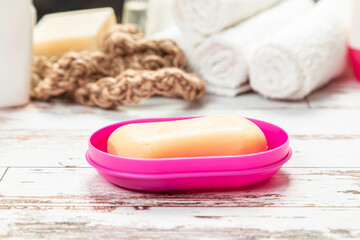 Fototapeta na wymiar soap on a pink soap dish isolated on white background. hygiene cleanliness travel concept