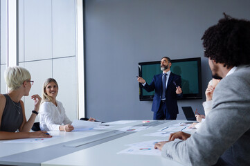 Fototapeta premium Group of business people discussing project in the office. Meeting, teamwork concept.
