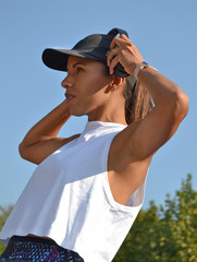 Workout latin woman with headphones on outdoors background.