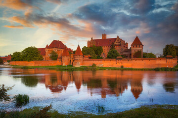 Fototapeta na wymiar Malbork castle over the Nogat river at sunset, Poland