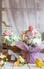 Easter composition with orthodox sweet breads or kulich decorated with white sugar icing and mastic flowers. Traditional Orthodox cake. Holiday concept.