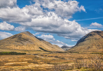 Scottish Highlands with deep valley against cloudy sky in Scotland