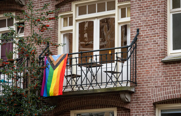 Pride flag on a balcony of a building in Amsterdam, The Netherlands