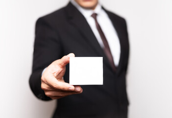 businessman holding a business card