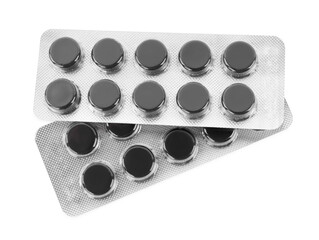 Activated charcoal pills in blisters on white background, top view. Potent sorbent