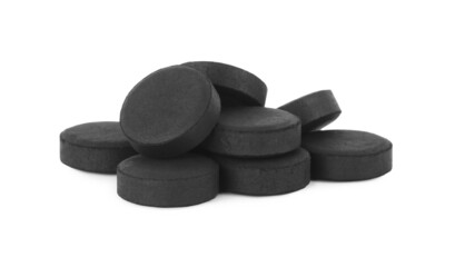 Activated charcoal pills on white background. Potent sorbent
