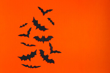 Happy Halloween. Paper bats on orange background.