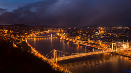 Panorama of night-time Budapest with illuminated bridges over the Danube River. 