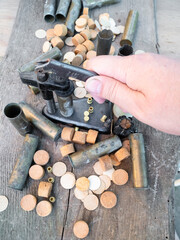 hand presses reloading press with cartridge case closeup on plank