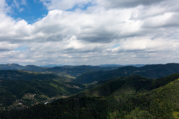 Mountain and forest with dramatic cloudy sky