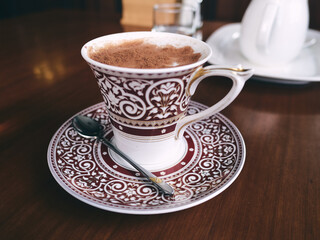 a cup of coffee in a fancy cup 