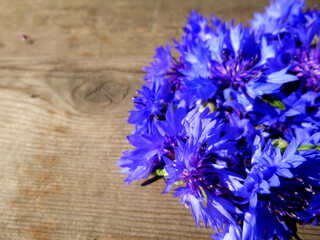 Cornflower flowers. Blue flowers on a background of a wooden surface