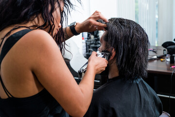 master hairdresser does hairstyle and style with scissors and comb, Barber shop