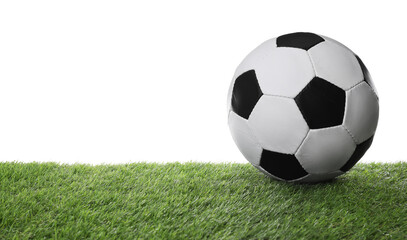 Fototapeta na wymiar Football ball on green grass against white background. Space for text