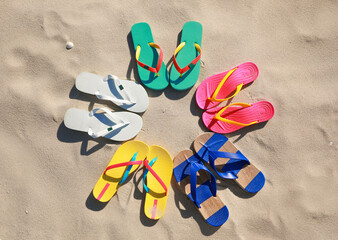 Fototapeta na wymiar Stylish flip flops on beach, flat lay