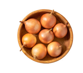 yellow onions in a wooden bowl isolated on white background, top view.