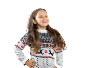 portrait of laughing, dancing girl in white knitted Christmas sweater with reindeer rejoicing at...