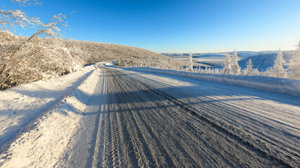 Straight empty snow covered automobile road in Kolyma, Yakutia, Russia