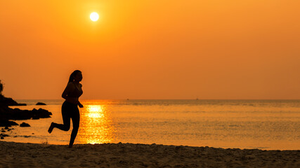 Fototapeta na wymiar Silhouette athletic woman jogging exercise and relax and freedom on sand beach. People running and workout in sunset background. Lifestyle and Healthy Concept.