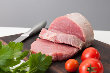 Piece of fresh raw meat on wooden cutting board
