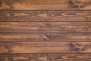 Background from wooden planks to dark charred aged wood, lying horizontally. Empty copy space