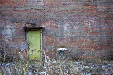 An iron door in a brick wall.