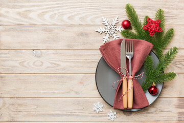 Christmas table place setting with christmas decor and plates, kine, fork and spoon. Christmas...