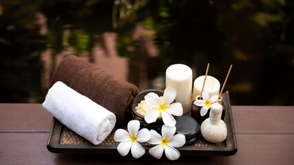 Spa beauty massage healthy wellness background. Spa Thai therapy treatment aromatherapy for body woman with flower Plumeria nature candle for relax summer time. Lifestyle and Cosmetic Concept