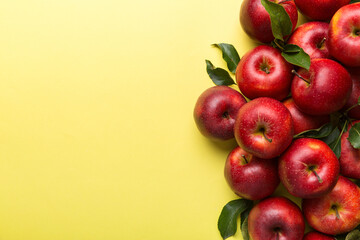 Many red apples on colored background, top view. Autumn pattern with fresh apple above view with copy space for design or text