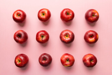Many red apples on colored background, top view. Autumn pattern with fresh apple above view