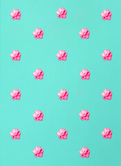 Tropical summer flower pattern. Pastel pink oleander flowers on turquoise color  background. Minimal exotic flat lay concept.