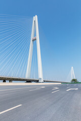 empty asphalt road and cable-stayed bridge background