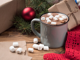 Hot chocolate with marshmallows and Christmas decor on a wooden table. Copy space.